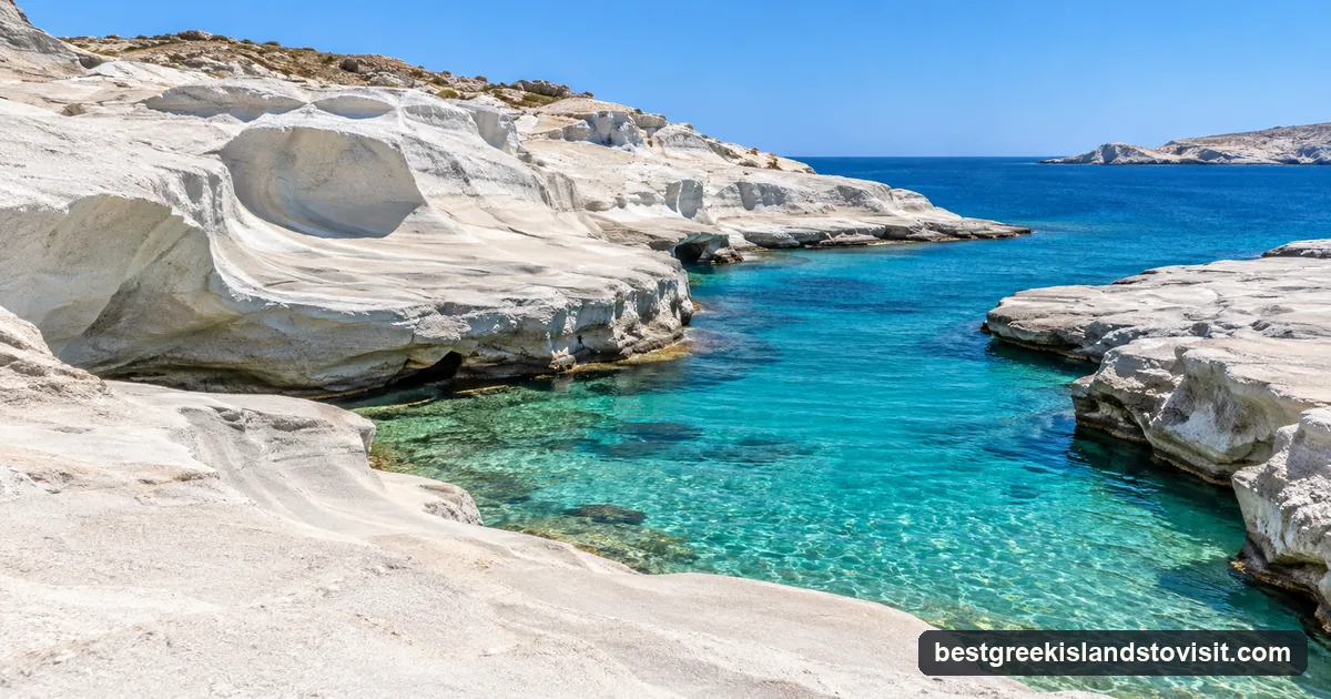 Smooth white volcanic rock sloping into a narrow inlet of bright turquoise water